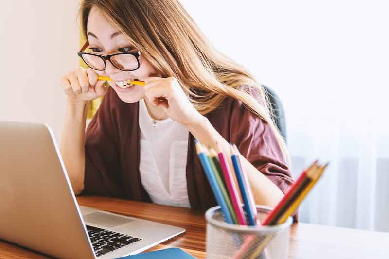 voyageuse stressée qui cherche un vol pas cher sur son ordinateur