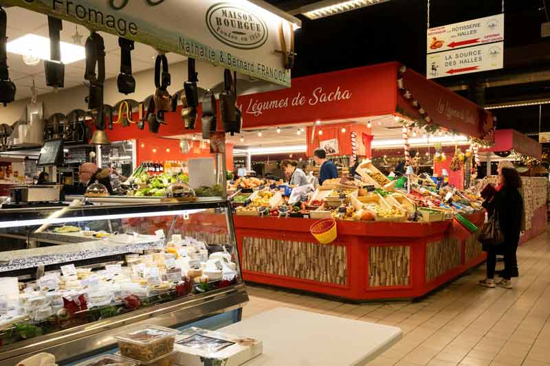 Étals colorés des Halles d'Avignon avec fromagerie et primeurs